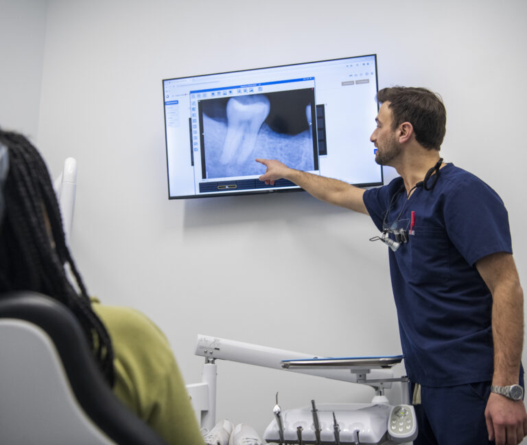 Dr. Uram patient and helpful reviewing xrays regarding a endodontics procedure